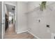 Laundry room with white wire shelving, washer/dryer hookups, and tile flooring at 4869 Antrim Dr, Sarasota, FL 34240