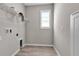 Functional laundry room featuring a rack, utility connections, and wood-look tile flooring at 4869 Antrim Dr, Sarasota, FL 34240