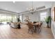 Open-concept living room featuring a dining area, sliding glass doors, and modern furnishings at 4869 Antrim Dr, Sarasota, FL 34240