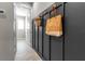 Stylish mudroom with board and batten accent, complete with storage hooks and decorative grocery bag at 4869 Antrim Dr, Sarasota, FL 34240