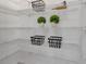 Organized pantry with wire shelving, baskets, and decorative plants for a neat and stylish storage solution at 4869 Antrim Dr, Sarasota, FL 34240