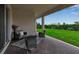 Relaxing covered patio with furniture and a view of the manicured lawn at 4869 Antrim Dr, Sarasota, FL 34240