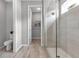 The modern glass shower features attractive finishes, along with a view into the WC and closet at 4869 Antrim Dr, Sarasota, FL 34240