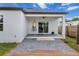 A covered back patio with a ceiling fan overlooking the backyard at 4920 69Th N St, St Petersburg, FL 33709