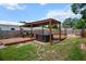 Wide-angle view of the wooden deck, hot tub and pergola in the backyard at 4920 69Th N St, St Petersburg, FL 33709