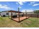 Backyard features a hot tub, pergola with bench seating and wood deck at 4920 69Th N St, St Petersburg, FL 33709