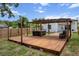 Backyard featuring a wooden deck, hot tub, and shaded pergola for outdoor enjoyment at 4920 69Th N St, St Petersburg, FL 33709