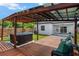A pergola covered wooden deck, bench seating and hot tub are great for relaxing at 4920 69Th N St, St Petersburg, FL 33709