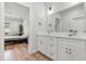 Bathroom featuring a double sink vanity leading into main bedroom at 4920 69Th N St, St Petersburg, FL 33709
