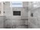 Bathroom featuring modern glass shower with gray tiling and a window at 4920 69Th N St, St Petersburg, FL 33709