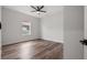 This bedroom offers wood-look flooring and a ceiling fan at 4920 69Th N St, St Petersburg, FL 33709