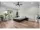 Bright bedroom featuring neutral tones, modern ceiling fan, and laminate flooring at 4920 69Th N St, St Petersburg, FL 33709