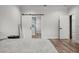 Bright bedroom with modern gray decor, wood floors, and barn door to ensuite bath at 4920 69Th N St, St Petersburg, FL 33709