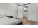 Bright bedroom with modern gray decor, wood floors, and barn door to ensuite bath at 4920 69Th N St, St Petersburg, FL 33709