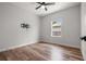 This bedroom offers wood-look flooring, a ceiling fan, and a TV mount at 4920 69Th N St, St Petersburg, FL 33709