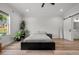 Bright bedroom with modern gray decor, wood floors, and barn door to ensuite bath at 4920 69Th N St, St Petersburg, FL 33709