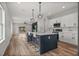 Open-concept kitchen with a large island, modern appliances, and seamless flow to the living area at 4920 69Th N St, St Petersburg, FL 33709