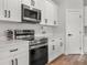 Modern kitchen featuring quartz countertops, stainless steel appliances, and sleek white cabinetry at 4920 69Th N St, St Petersburg, FL 33709