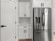 Kitchen featuring stainless steel refrigerator and white cabinets at 4920 69Th N St, St Petersburg, FL 33709