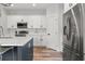 Modern kitchen with stainless steel appliances, quartz countertops, a large island, and ample storage at 4920 69Th N St, St Petersburg, FL 33709