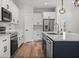 Bright kitchen boasts an island with seating, stainless appliances, modern cabinetry, and stylish pendant lighting at 4920 69Th N St, St Petersburg, FL 33709