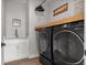 This laundry room offers a utility sink and modern washer and dryer units at 4920 69Th N St, St Petersburg, FL 33709