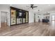 Spacious open-concept living room with view to kitchen, featuring a custom built-in entertainment center at 4920 69Th N St, St Petersburg, FL 33709