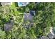 Aerial view of the home with a large backyard, swimming pool, and mature trees offering ample shade at 5103 Twin Creeks Dr, Valrico, FL 33596