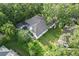 Aerial view of the house with a backyard and a screened in pool, surrounded by mature trees at 5103 Twin Creeks Dr, Valrico, FL 33596
