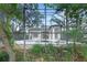 The serene, private backyard features a screened-in pool and spa, surrounded by lush, mature landscaping at 5103 Twin Creeks Dr, Valrico, FL 33596