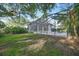 The private backyard features a screened-in pool and spa, lush landscaping, and ample space for recreation at 5103 Twin Creeks Dr, Valrico, FL 33596