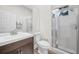 Bathroom featuring a shower, white tiling, modern vanity, and neutral color scheme at 5103 Twin Creeks Dr, Valrico, FL 33596