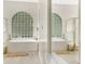 Bright white bathroom with jetted tub and glass block window at 5103 Twin Creeks Dr, Valrico, FL 33596