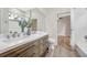 Bathroom features a dual sink vanity, wood drawers, and modern fixtures at 5103 Twin Creeks Dr, Valrico, FL 33596