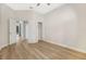 Spacious bedroom with hardwood floors, neutral paint, and open doorway to the pool at 5103 Twin Creeks Dr, Valrico, FL 33596