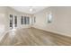 Bright bedroom featuring hardwood floors, large windows, and French doors to a patio at 5103 Twin Creeks Dr, Valrico, FL 33596