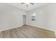 Empty bedroom with wood-look floors and a single window at 5103 Twin Creeks Dr, Valrico, FL 33596