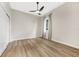 Bedroom features wood-look floors, a ceiling fan, a window, and a closet at 5103 Twin Creeks Dr, Valrico, FL 33596
