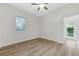 Bright bedroom featuring a ceiling fan, a window, and wood-look flooring at 5103 Twin Creeks Dr, Valrico, FL 33596