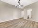 Bedroom features wood-look floors, a ceiling fan, and en-suite bathroom at 5103 Twin Creeks Dr, Valrico, FL 33596