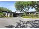 Beautiful building with stone features surrounded by palm trees and manicured landscaping at 5103 Twin Creeks Dr, Valrico, FL 33596