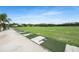 The driving range is well-maintained with lush green grass and provides an open space for golfers at 5103 Twin Creeks Dr, Valrico, FL 33596