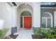 This home has a double door front entrance with archways and side panel windows for brightness at 5103 Twin Creeks Dr, Valrico, FL 33596