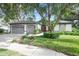 Charming one-story home featuring a well-manicured lawn and a driveway leading to the two-car garage at 5103 Twin Creeks Dr, Valrico, FL 33596