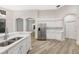 Kitchen with stainless steel refrigerator, light countertops, and white cabinets at 5103 Twin Creeks Dr, Valrico, FL 33596