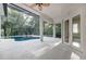 Screened-in lanai boasts a pool with spa and ample space for outdoor living with french door access to interior at 5103 Twin Creeks Dr, Valrico, FL 33596