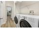 Laundry room equipped with shelving, a modern washer, and a modern dryer at 5103 Twin Creeks Dr, Valrico, FL 33596