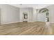 Open concept living area with hardwood floors and light and bright neutral paint at 5103 Twin Creeks Dr, Valrico, FL 33596