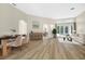 Open concept living room with dining area, with hardwood floors and neutral paint at 5103 Twin Creeks Dr, Valrico, FL 33596