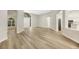 Spacious open living area featuring hardwood floors, neutral paint and a view to the kitchen at 5103 Twin Creeks Dr, Valrico, FL 33596
